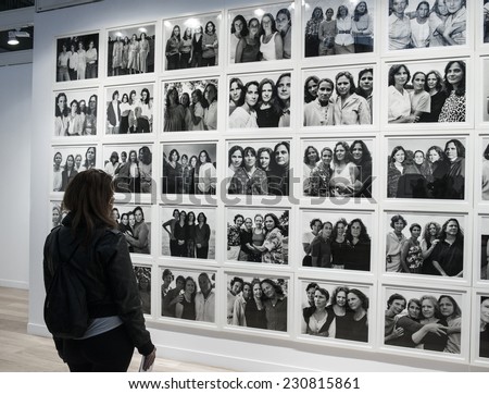 People looking at a photo of Nicholas Nixon at Paris Photo art fair 2014, Paris, France