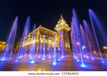 coloured jets water of fountain and the Main Guard building by night in the Venezia Huahin Thailand