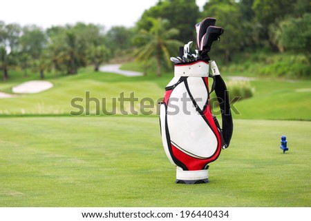 Golf game. Golf clubs in bag against the golf course