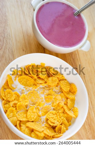 A country breakfast with blueberry  yogurt, milk and cornflakes in vintage style