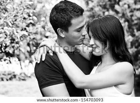 Black and white portrait of a happy embracing couple
