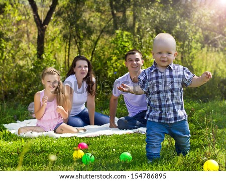 Family looking at first steps of little boy