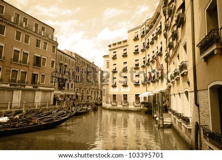 Venetian canal. The walls of old buildings. On the water, the gondola is. Imitation of antiques