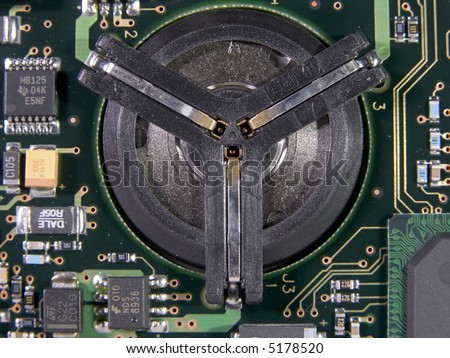 Hard drive spindle mount surrounded by a circuit board with surface mount components.