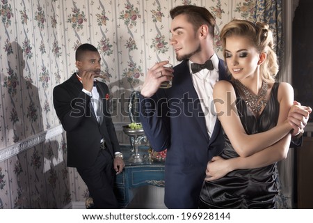 Beautiful, posh couple on the party in luxury apartment with friend