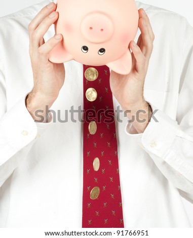 businessman getting money from a piggy bank