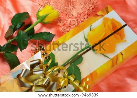 Yellow rose and box of sweets