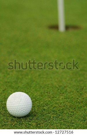 Golf ball in front of the hole