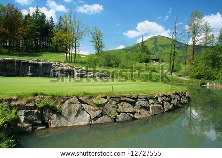 Golfcourse and beauty surroundings with water-jump