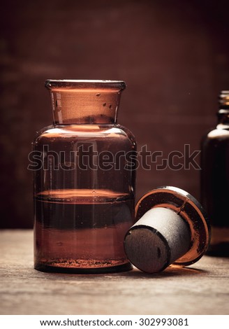 Old fashioned brown glass bottle. Conceptual image of historical clinical testing, scientific analysis and retro science.