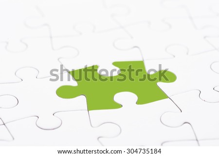 Puzzle pieces, one piece with green color texture. Conceptual image of connection, solution and business strategy.