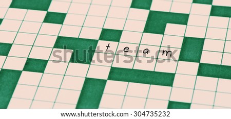 Closeup of crossword puzzle and the word team.