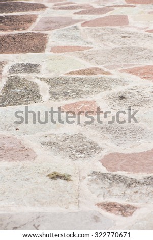 Stone floor in outdoor patio. Blocks of stones in mosaic pattern.