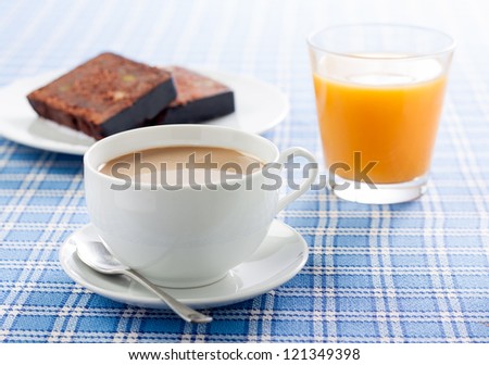 Delicious breakfast with coffee, orange juice and chocolate cake