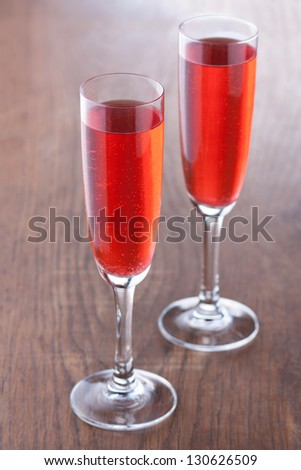 Kir royale cocktail prepared in the traditional way on wooden table