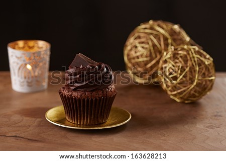 Black chocolate cupcake on black Christmas background