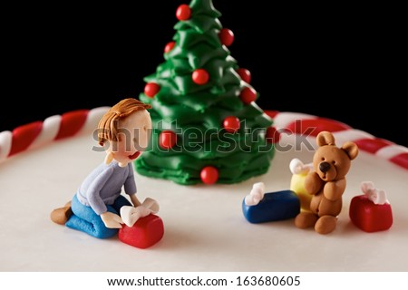 Fondant Christmas tree cake with a kid and presents detail