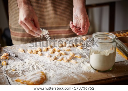 Similar – Image, Stock Photo Homemade gnocchi making preparation. Potatoes dough on dark rustic kitchen table with cutting board and healthy ingredients. Tasty home cuisine. Top view. Still life