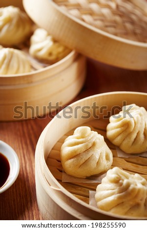 Baozi chinese dumplings on bamboo steamer