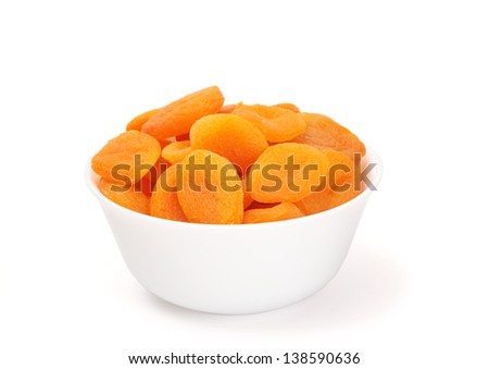 dried apricots in a bowl on white