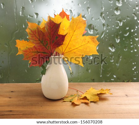 Bouquet of autumn leaves on  window sill