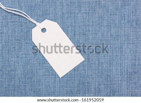 Blank paper label tag on  blue jeans