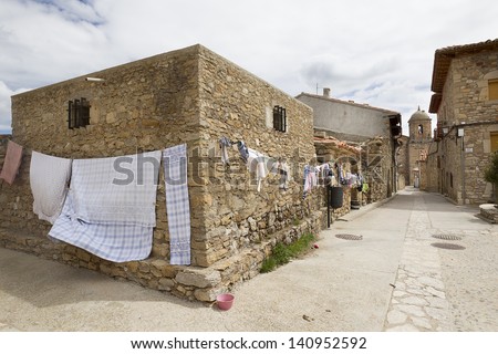 wash clothes drying in the sun in a village with stone houses in Spain