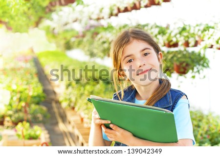 little girl in the garden flowers