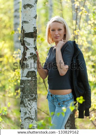 Pictures of the young blonde in a birch grove in the spring