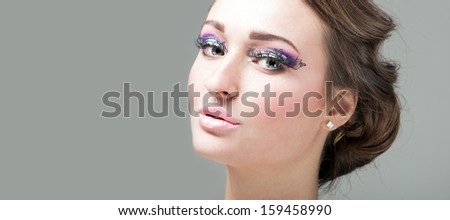Beautiful Girl. Healthy Hair and Holiday Makeup. False eyelashes in the form of butterflies.