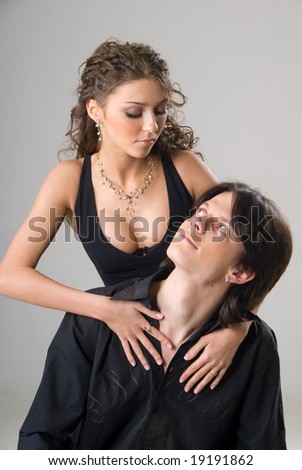 picture of a young sweet cople in love. Isolated on grey background