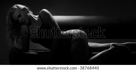 silhouette of a beautiful young woman lying on the couch