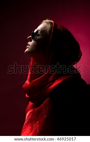 portrait of a young attractive girl in sunglasses and a scarf tied around his head