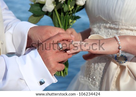 Bride and groom change rings at their wedding