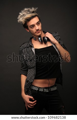 portrait of a young guy listening music on a head phones
