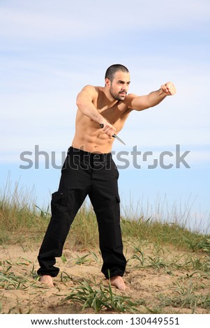 martial arts instructor holding a knife and practicing outdoor