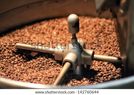 fresh coffee beans mix on a roast machine in a coffee shop