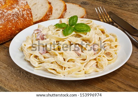 Plate of tagliatelli carbonara italian food in a rustic restaurant setting