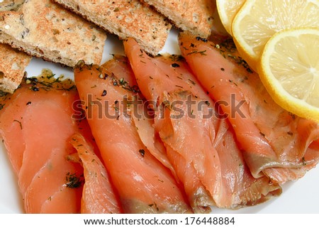 Smoked salmon sliced and arranged with toast a popular appetizer