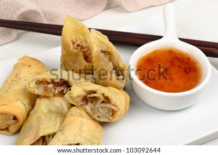 Spring Rolls - Fried vegetable spring rolls served with sweet chili sauce. Close up.