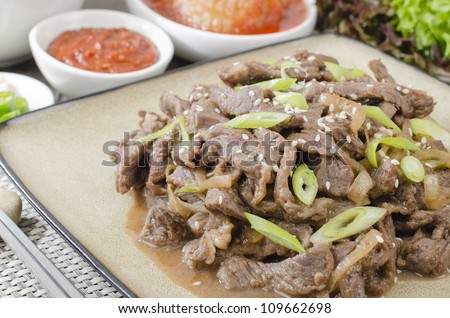 Beef Bulgogi - Korean marinated BBQ beef served with kimchi, ssamjang, chillies, garlic and lettuce leaves.