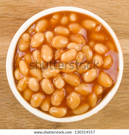 Baked Beans - Bowl of baked beans in tomato sauce. Shot from above.