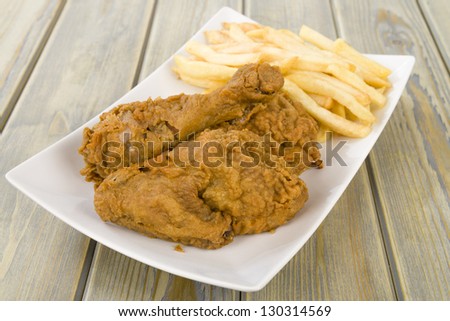Fried Chicken & Chips - Chicken pieces on the bone coated in a spicy flour and deep fried served with fries.