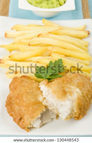 Fish & Chips served with mushy peas. A popular British traditional meal!