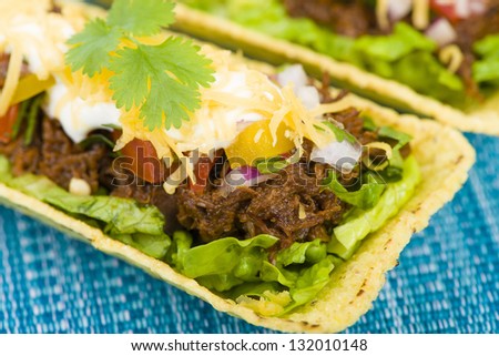 Beef Tacos - Shredded beef taco trays topped with salsa, sour cream and grated cheese.