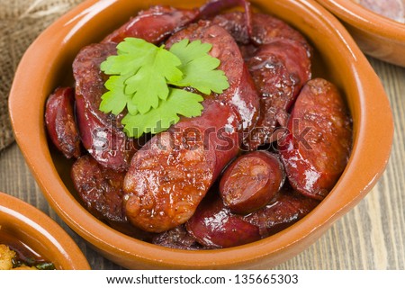Chorizo al Vino (Spicy sausage cooked in red wine). Traditional Spanish tapas dish.