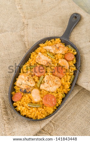 Paella Valenciana - Traditional Valencian paella with white rice, chicken, sausage, butter beans and green vegetables.