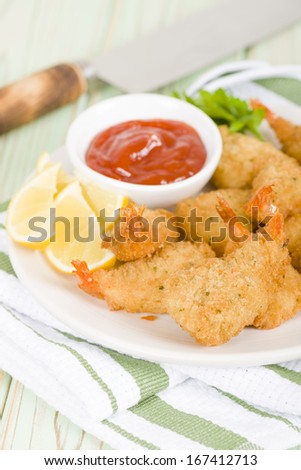 Breaded Butterfly Prawns - Deep fried battered prawns filled with garlic sauce served with chili sauce and lemon wedges.