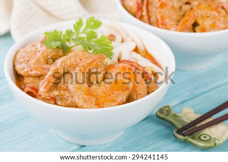 Thai Prawn Curry with Noodles - Thai red curry with prawns served with rice noodles in a white bowl.