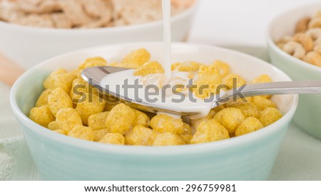 Golden Nuggets - Milk being poured in a bowl of whole grain cerails.